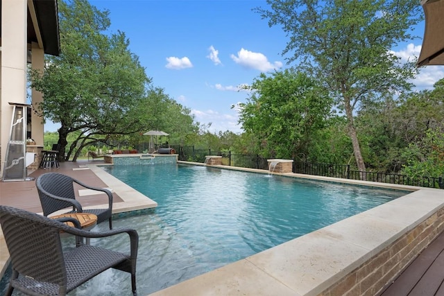 view of pool featuring pool water feature, a patio area, and an in ground hot tub