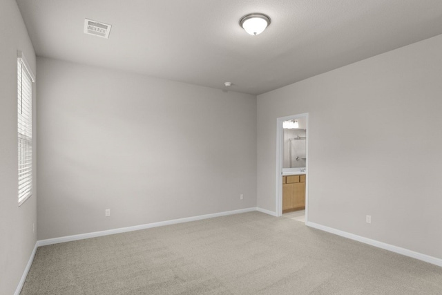 unfurnished room with light carpet