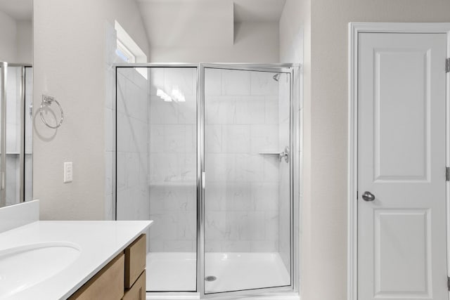 bathroom with walk in shower and vanity