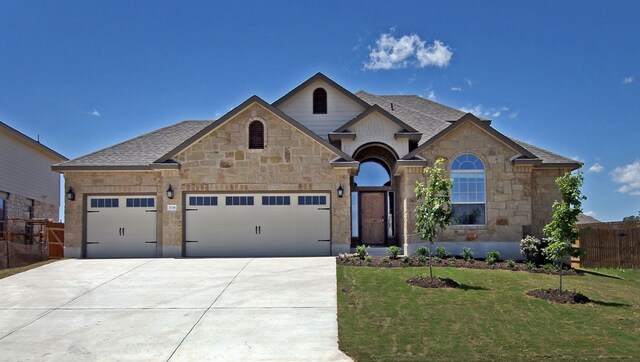 view of front facade featuring a garage and a front lawn