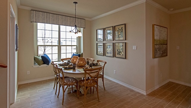 dining area with a chandelier and crown molding