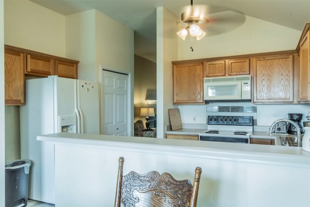 kitchen featuring white appliances, sink, lofted ceiling, and ceiling fan