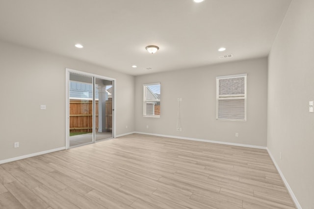 spare room with light wood-type flooring