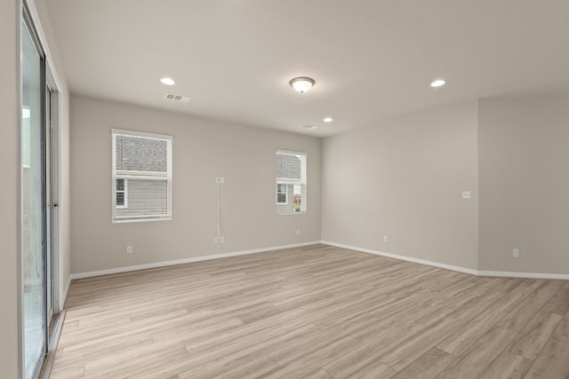 spare room with light hardwood / wood-style flooring