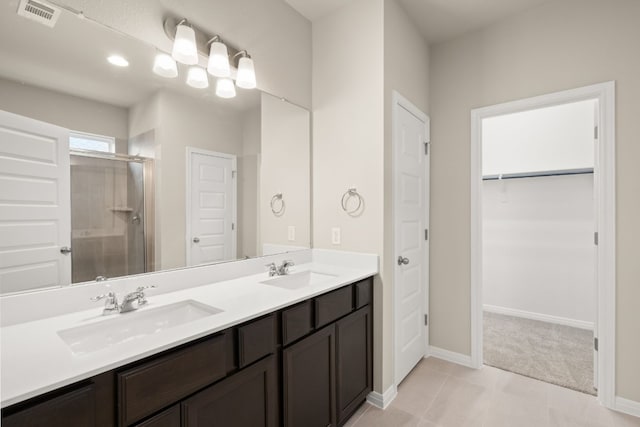 bathroom featuring tile patterned floors, vanity, and an enclosed shower