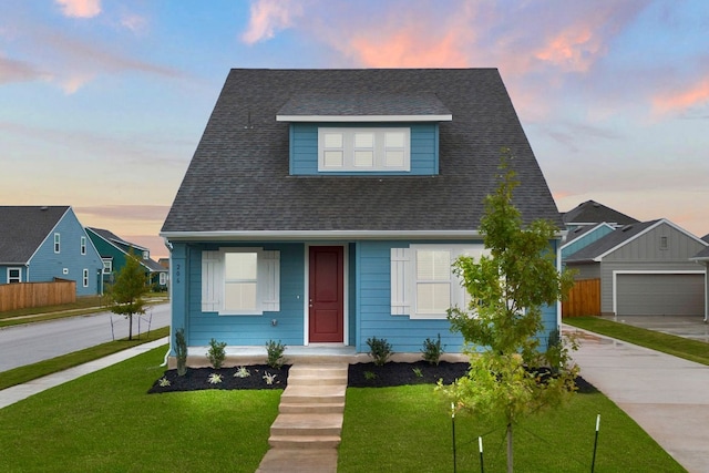 view of front of house with a yard, an outdoor structure, and a garage