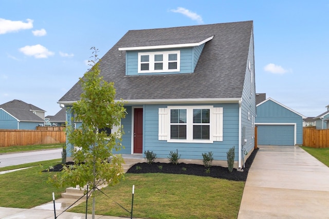 view of front facade featuring an outbuilding, a front lawn, and a garage