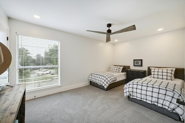 carpeted bedroom with ceiling fan and multiple windows