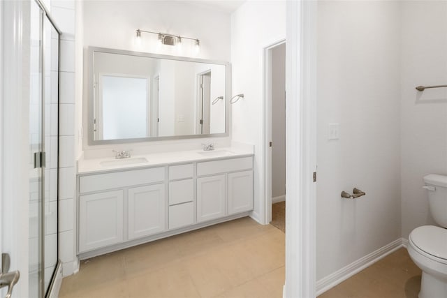 bathroom with tile patterned floors, toilet, vanity, and walk in shower