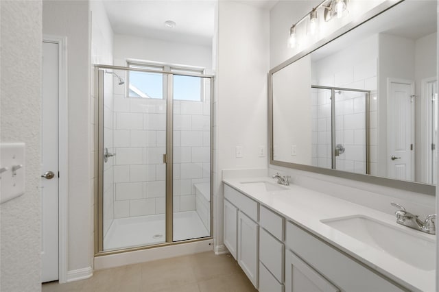 bathroom featuring a shower with shower door, tile patterned floors, and vanity