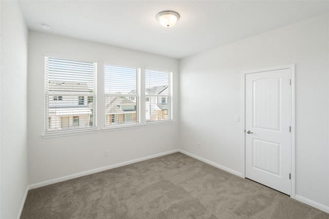 unfurnished room with light colored carpet