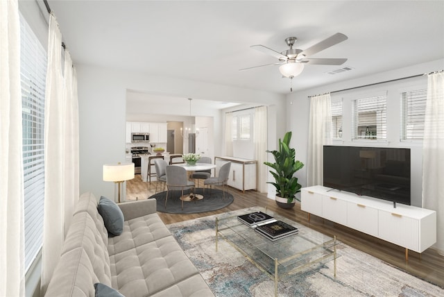 living room featuring ceiling fan and hardwood / wood-style floors