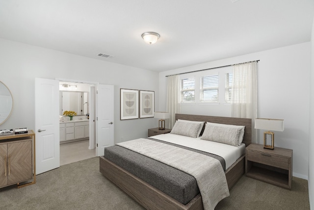 carpeted bedroom with ensuite bathroom