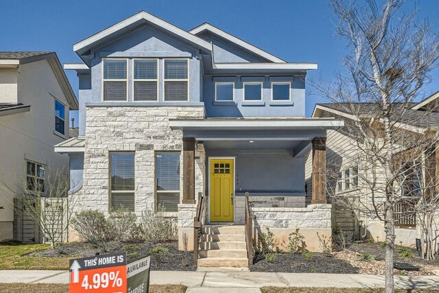view of front of property with stone siding and stucco siding