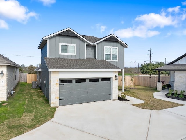 view of front facade featuring a garage, a front lawn, and central air condition unit