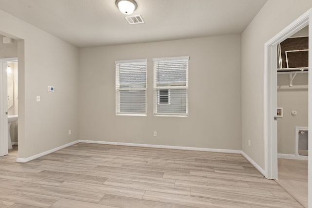 unfurnished room with light hardwood / wood-style floors