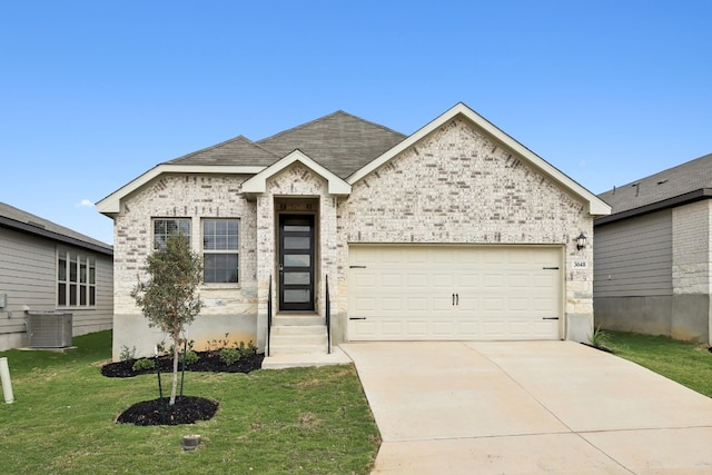 view of front of property with a garage, central air condition unit, and a front lawn