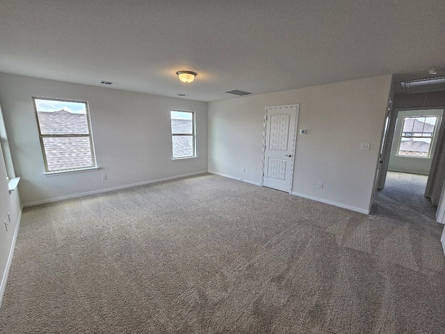 spare room with carpet and a textured ceiling