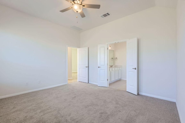 unfurnished bedroom with visible vents, ceiling fan, baseboards, light carpet, and ensuite bathroom