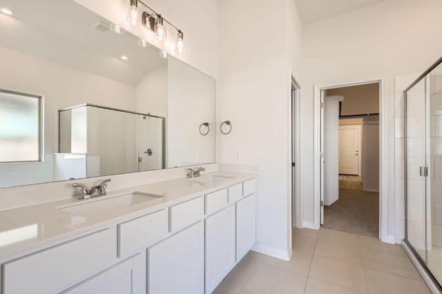 full bathroom with tile patterned floors, a shower stall, double vanity, and a sink