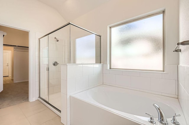 bathroom featuring plenty of natural light, a garden tub, a shower stall, and tile patterned flooring