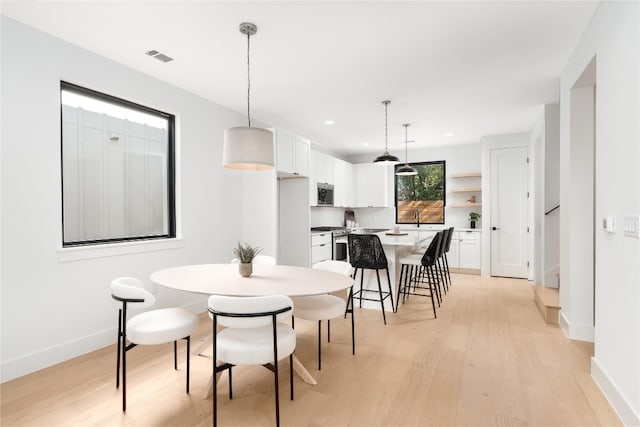 dining space featuring light wood-type flooring