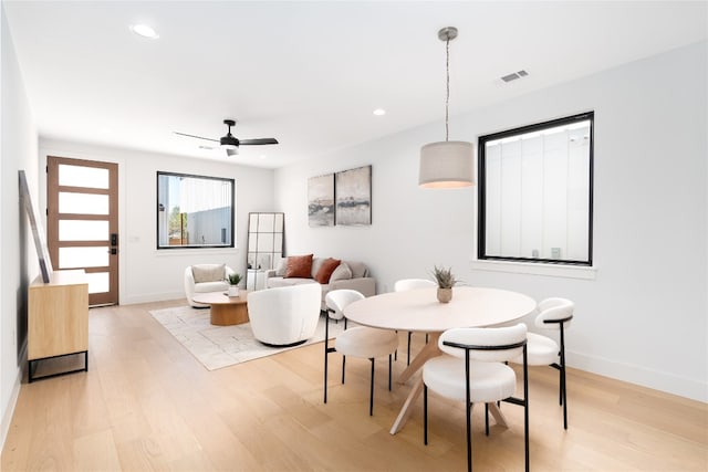 dining room with ceiling fan and light wood-type flooring