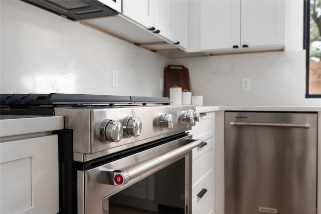 kitchen featuring tasteful backsplash, white cabinetry, and appliances with stainless steel finishes