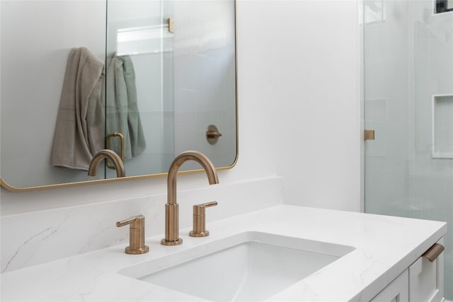 bathroom featuring vanity and an enclosed shower