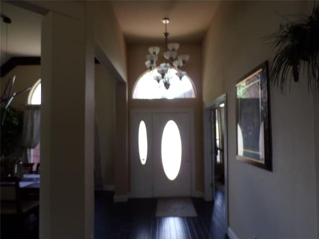 entryway with a chandelier