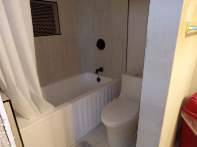 bathroom featuring shower / bath combination with curtain and toilet