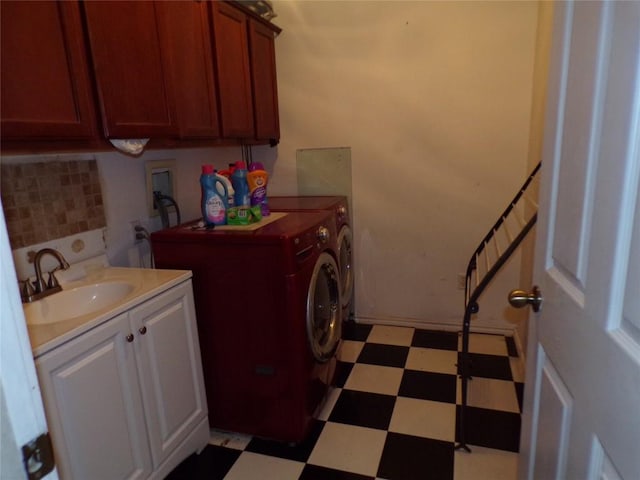 laundry area with washer and dryer, cabinets, and sink