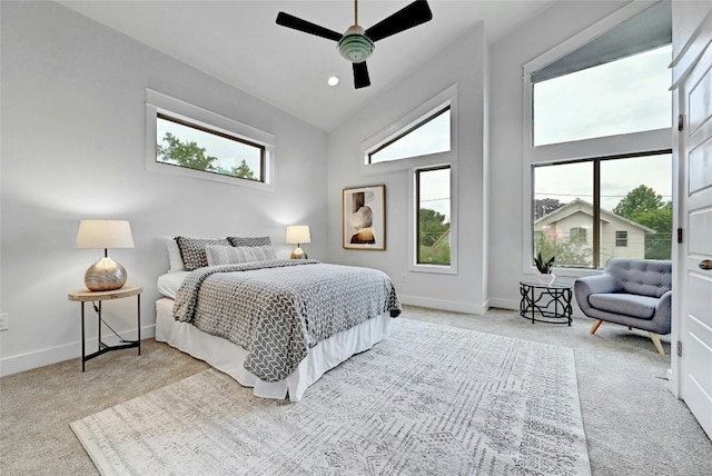 bedroom with light colored carpet, ceiling fan, and lofted ceiling