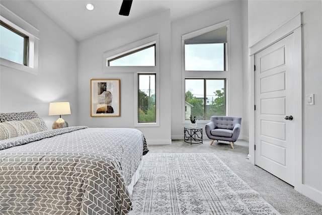 bedroom featuring ceiling fan, light colored carpet, and lofted ceiling