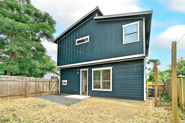 rear view of property featuring cooling unit