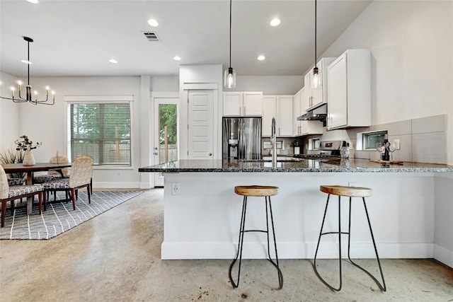 kitchen featuring pendant lighting, white cabinets, sink, appliances with stainless steel finishes, and a chandelier