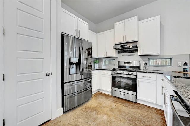 kitchen with appliances with stainless steel finishes, white cabinetry, and dark stone countertops