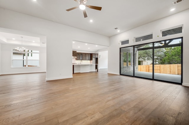 unfurnished living room featuring a healthy amount of sunlight, light wood-type flooring, and recessed lighting