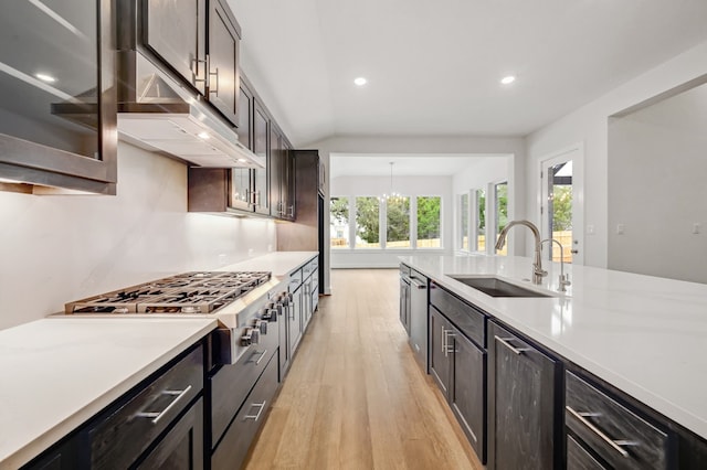 kitchen featuring recessed lighting, a sink, light wood-style flooring, and light countertops