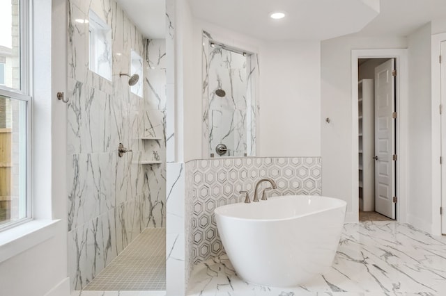 full bathroom with recessed lighting, a freestanding tub, plenty of natural light, and a marble finish shower
