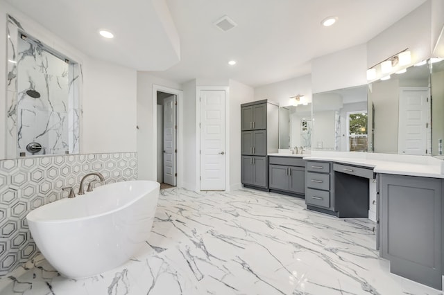 bathroom with recessed lighting, a freestanding tub, walk in shower, and vanity