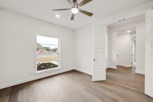 interior space featuring recessed lighting, baseboards, a ceiling fan, and wood finished floors