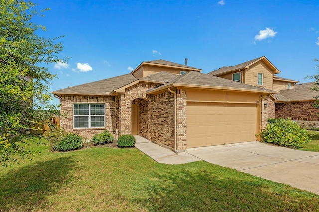 view of front of home with a front yard and a garage