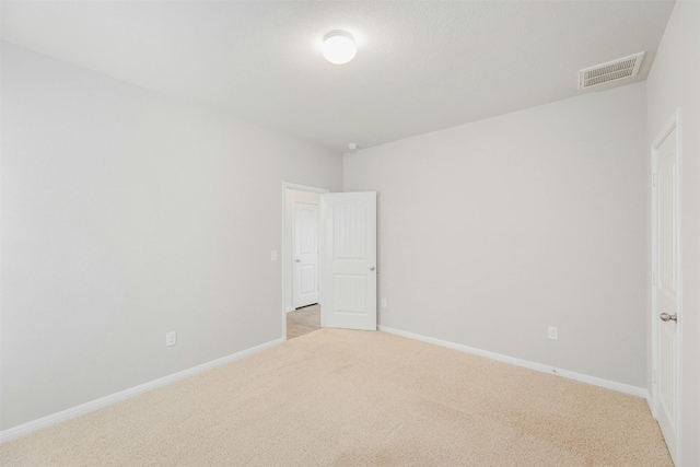 spare room with light carpet