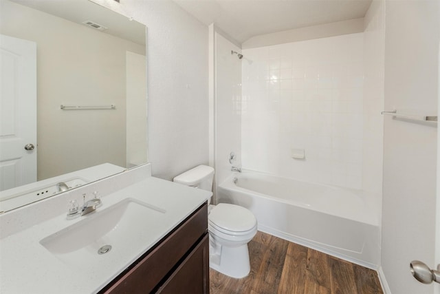 full bathroom with vanity,  shower combination, hardwood / wood-style flooring, and toilet