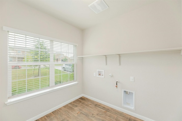 laundry area featuring hookup for a gas dryer, light hardwood / wood-style floors, and hookup for a washing machine