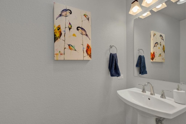 bathroom with a sink and a textured wall