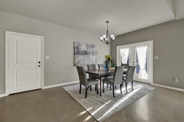 dining area featuring a chandelier, finished concrete flooring, baseboards, and french doors