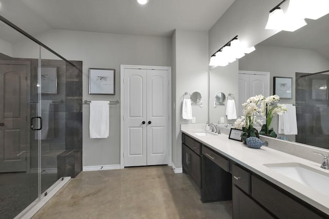 full bathroom featuring a shower stall, a sink, and lofted ceiling
