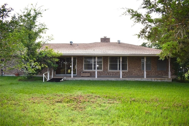 back of property featuring a lawn